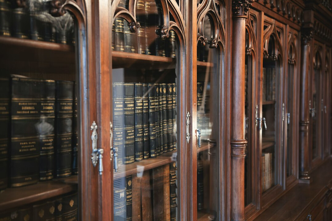 Old library with tall wooden bookshelves